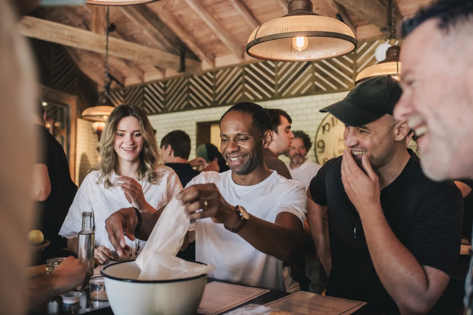 Teammates laughing around a counter during a cooking class at the Buenos Aires offsite.